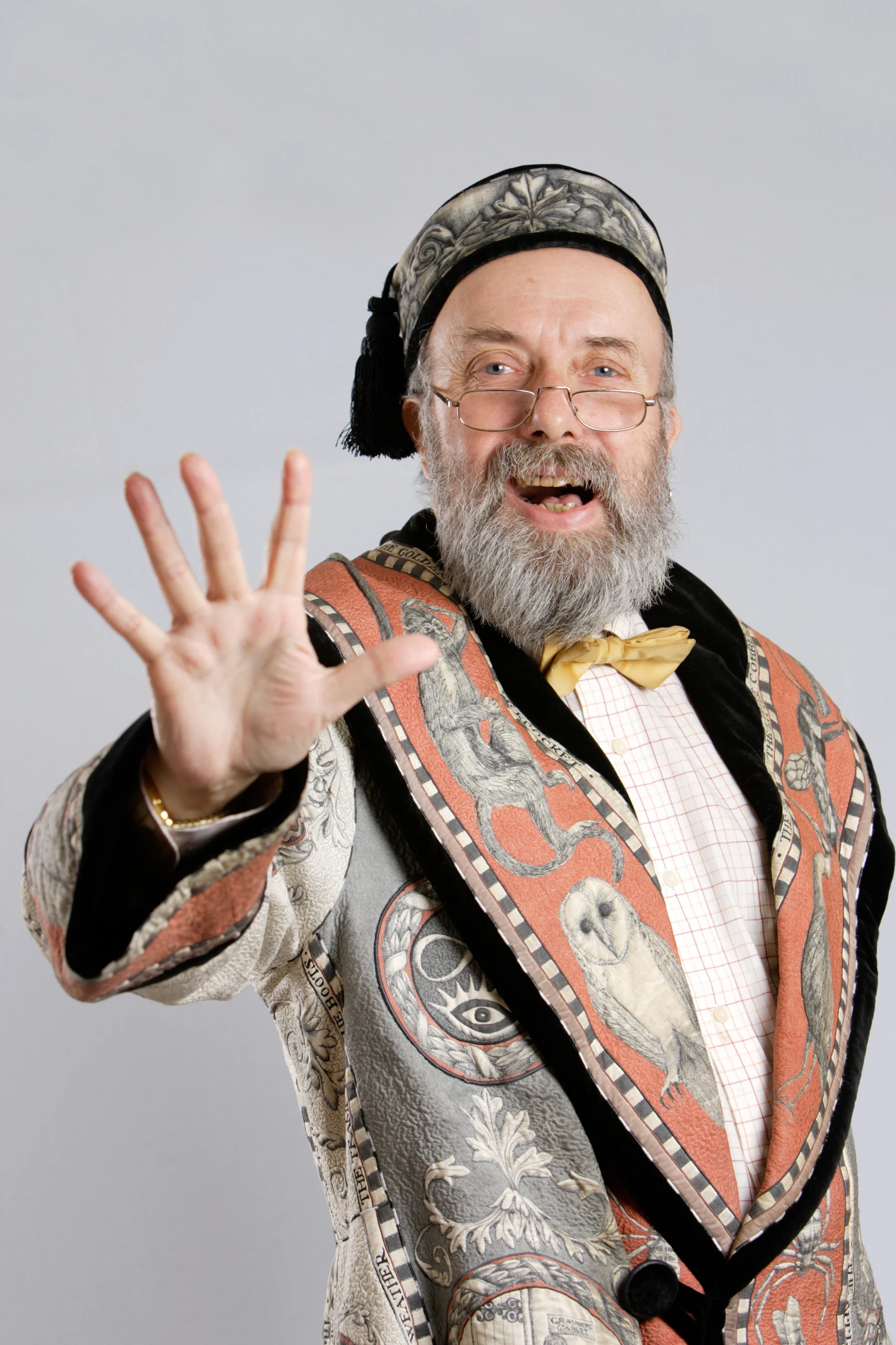Photo of the storyteller, Taffy Thomas, in his coat that is embroidered with imagery from all the stories he knows.